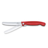 Victorinox Swiss Classic picnic knife in red, shown with the serrated blade partly folded